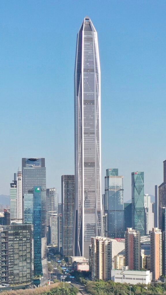 Ping An Finance Centre standing above the Shenzhen skyline, its tapered form narrowing to a spire-like crown.